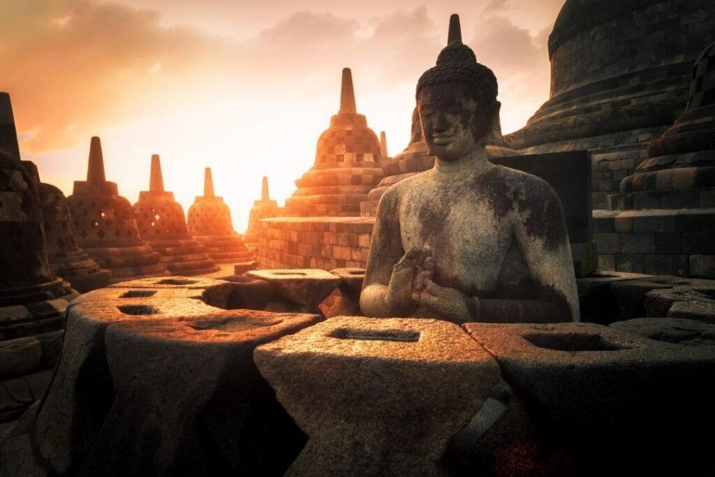 The ancient Borobudur Buddhist temple in Java, Indonesia, with rows of stone stupas at sunrise